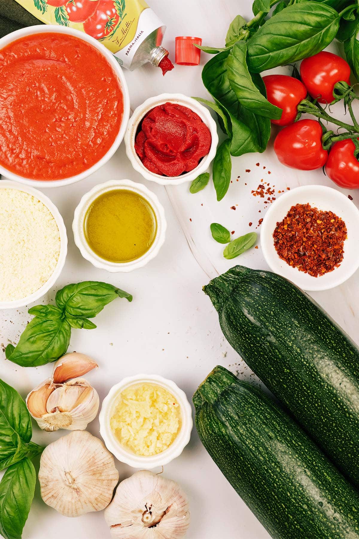 overhead view of ingredients to make Zucchini Parmesan on a table