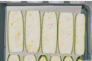 slices of zucchini laid out in rows to make Zucchini Parmesan