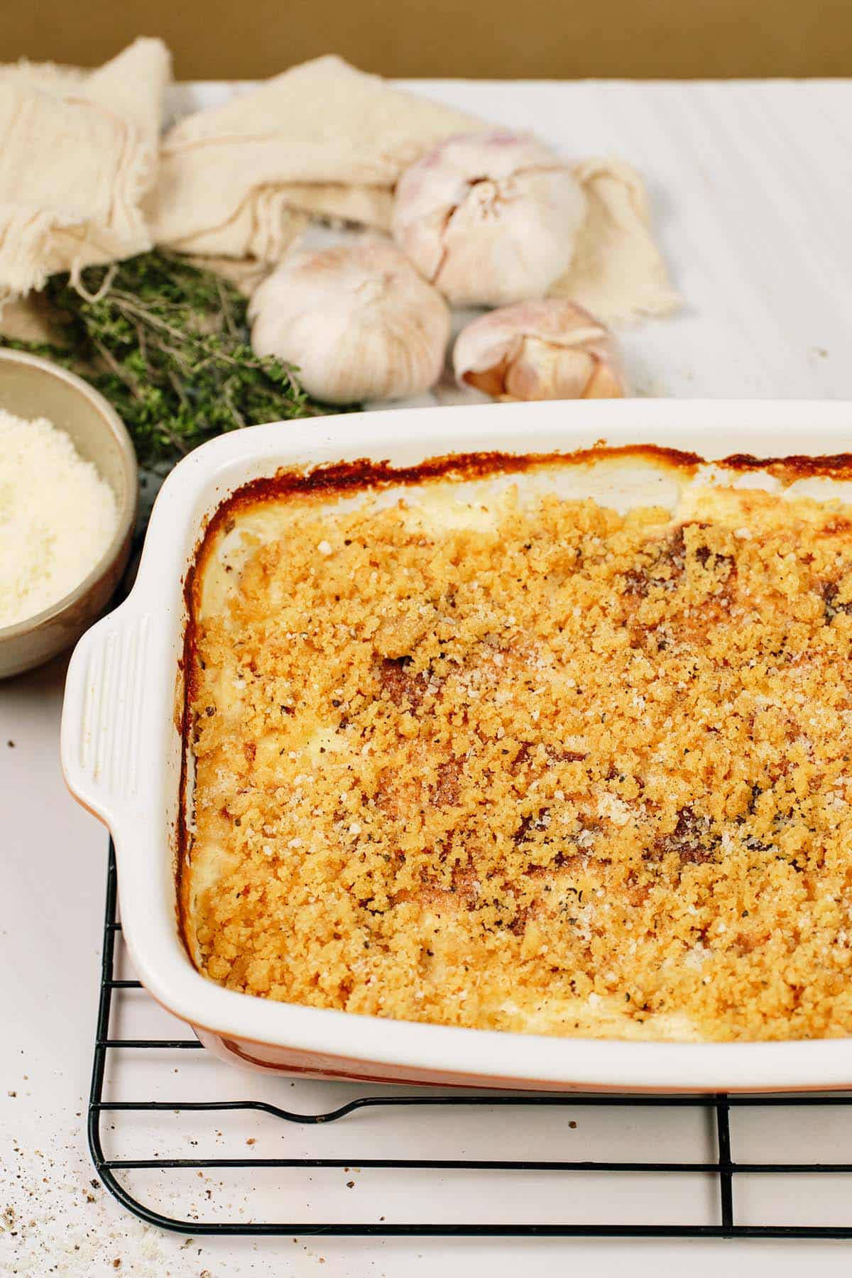 Cacio e Pepe Casserole in a baking dish resting on a wire rack