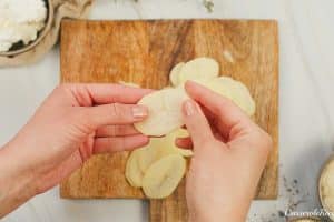 slicing potatoes to make Cacio e Pepe Casserole