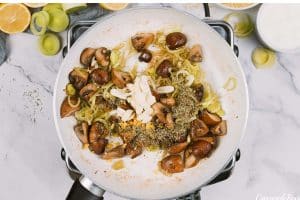 sautéing mushrooms and onions to make Chicken and Rosini Bake