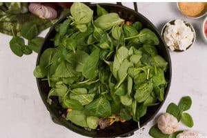 wilting spinach to make Mediterranean Chickpea Casserole