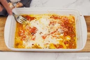 combining cheese and other ingredients to make the sauce for baked feta pasta