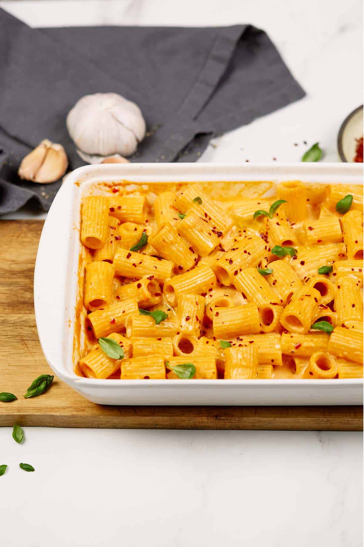 casserole dish on a table filled with baked feta pasta