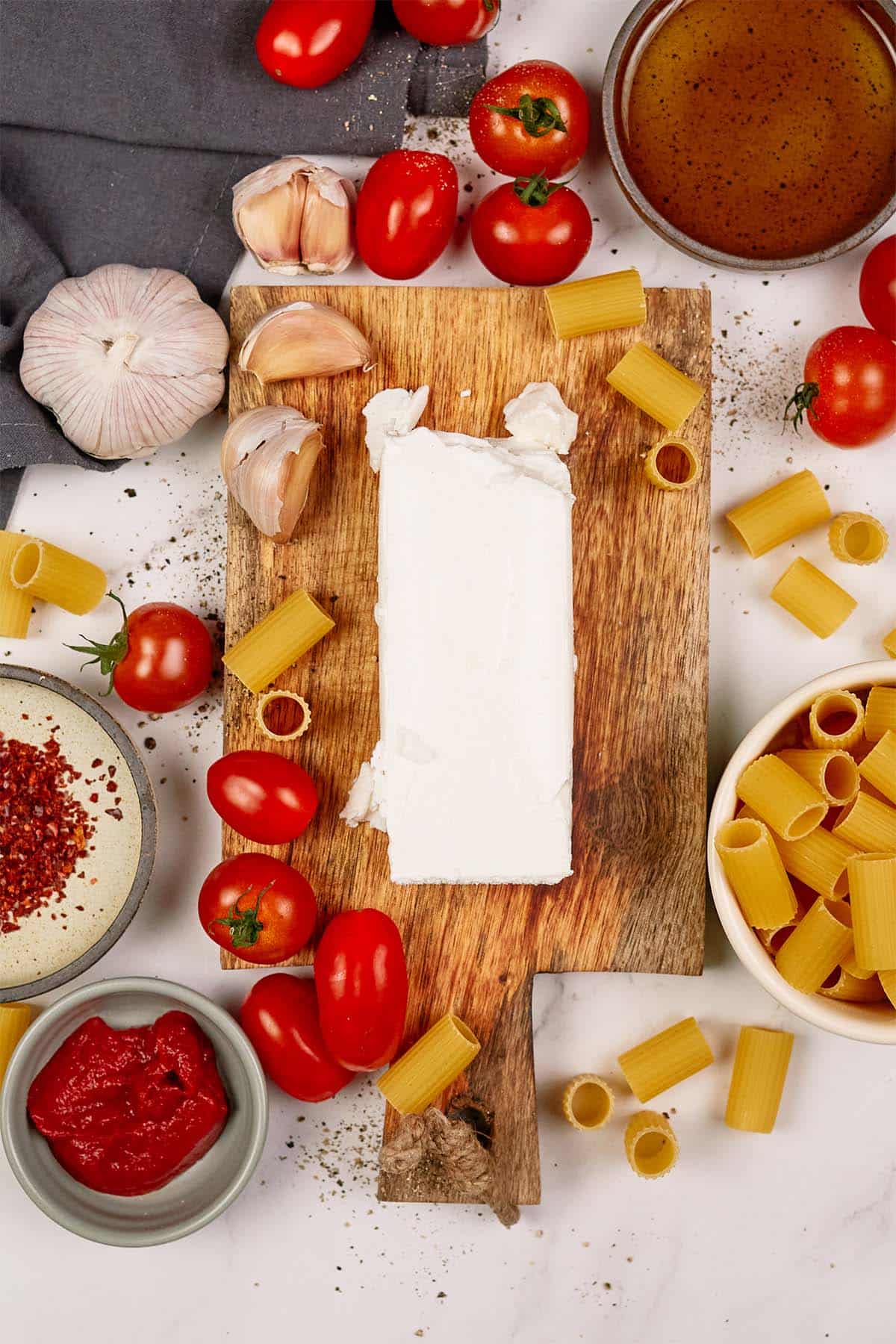 ingredients to make baked feta pasta on a table