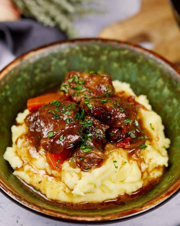 bowl with a serving of best beef casserole recipe on a table