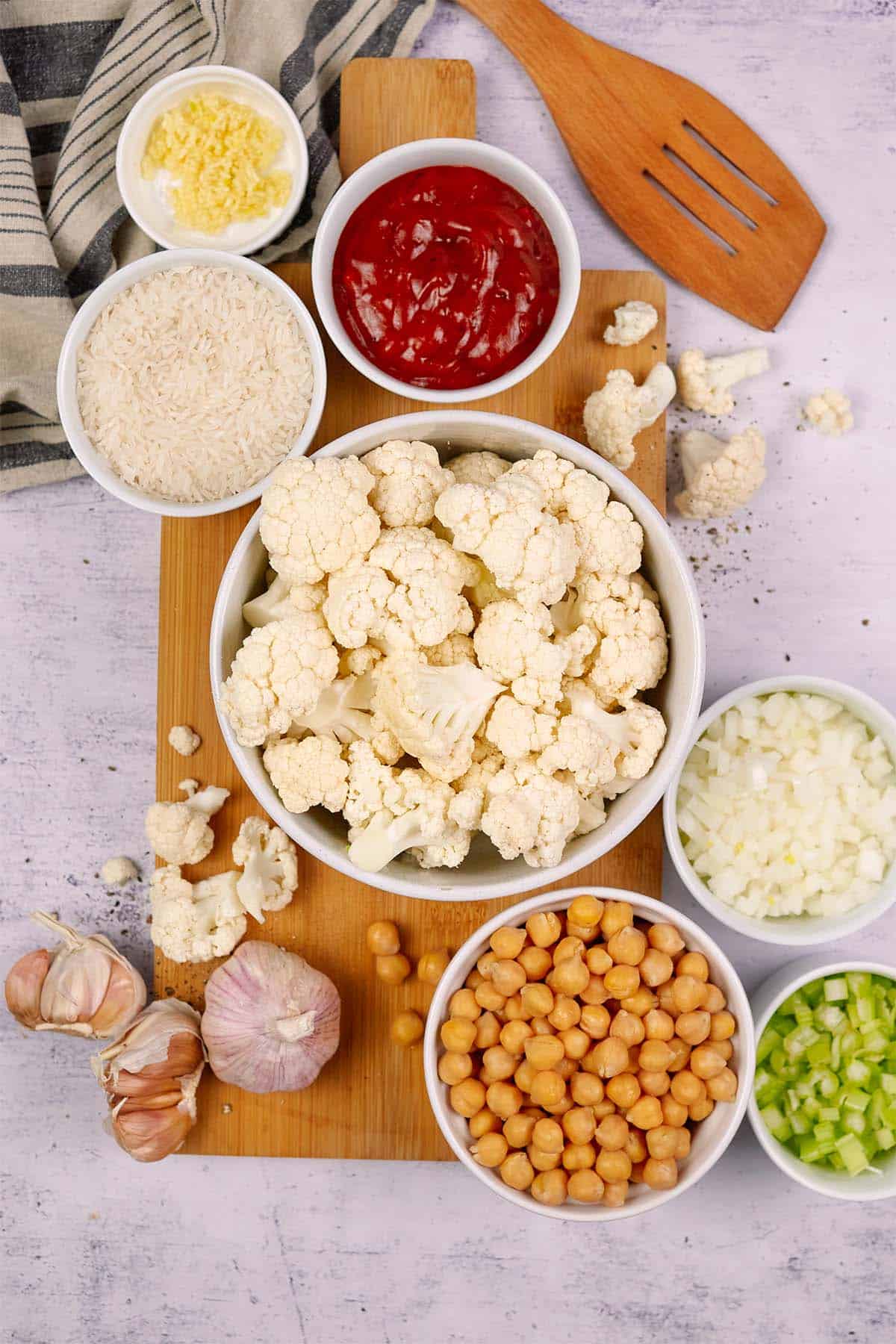 ingredients laid out on a table to make buffalo cauliflower and chickpea casserole