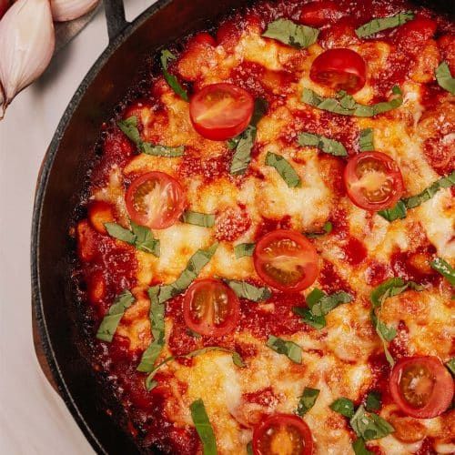 casserole dish filled with cheesy white bean tomato bake