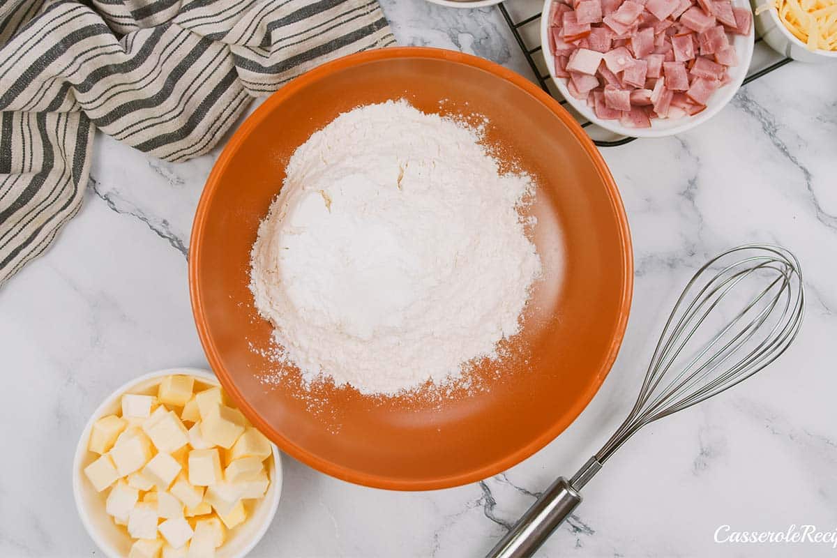 mixing together ingredients to make chicken cordon bleu bubble-up bake