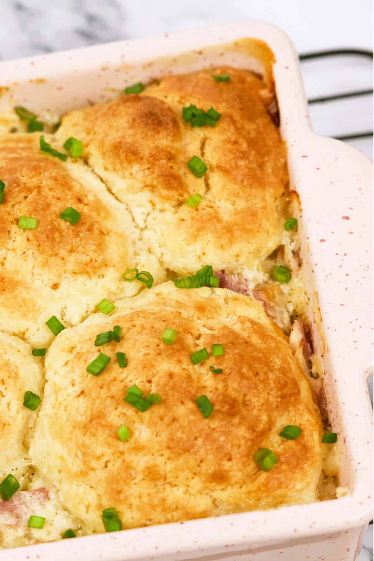 closeup of a baking dish of chicken cordon bleu bubble-up bake