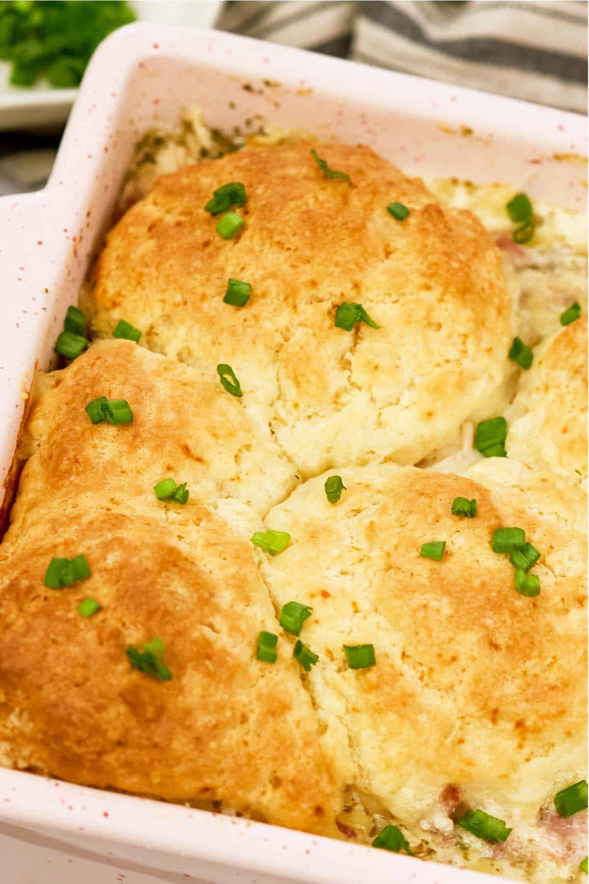 closeup of a baking dish of chicken cordon bleu bubble-up bake