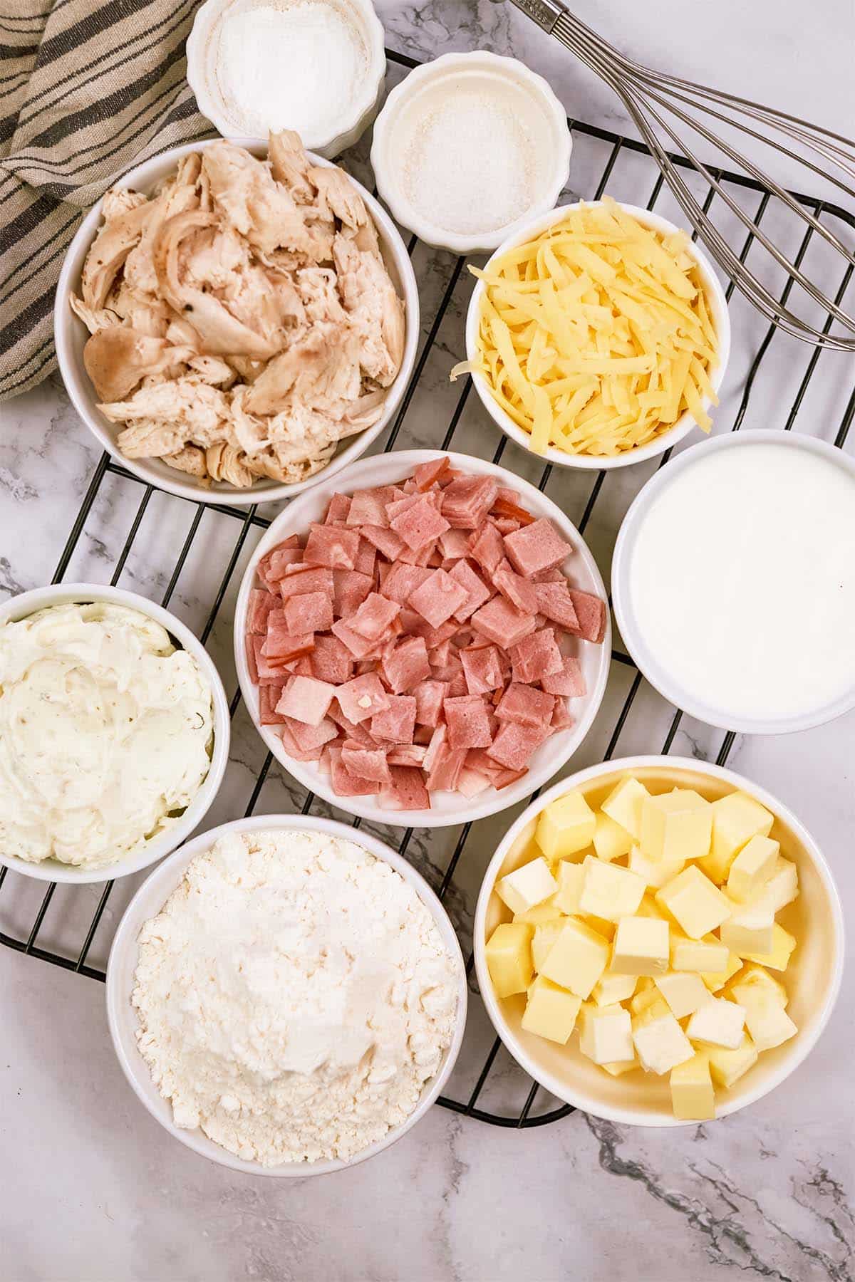 overhead view of ingredients to make chicken cordon bleu bubble-up bake on a table