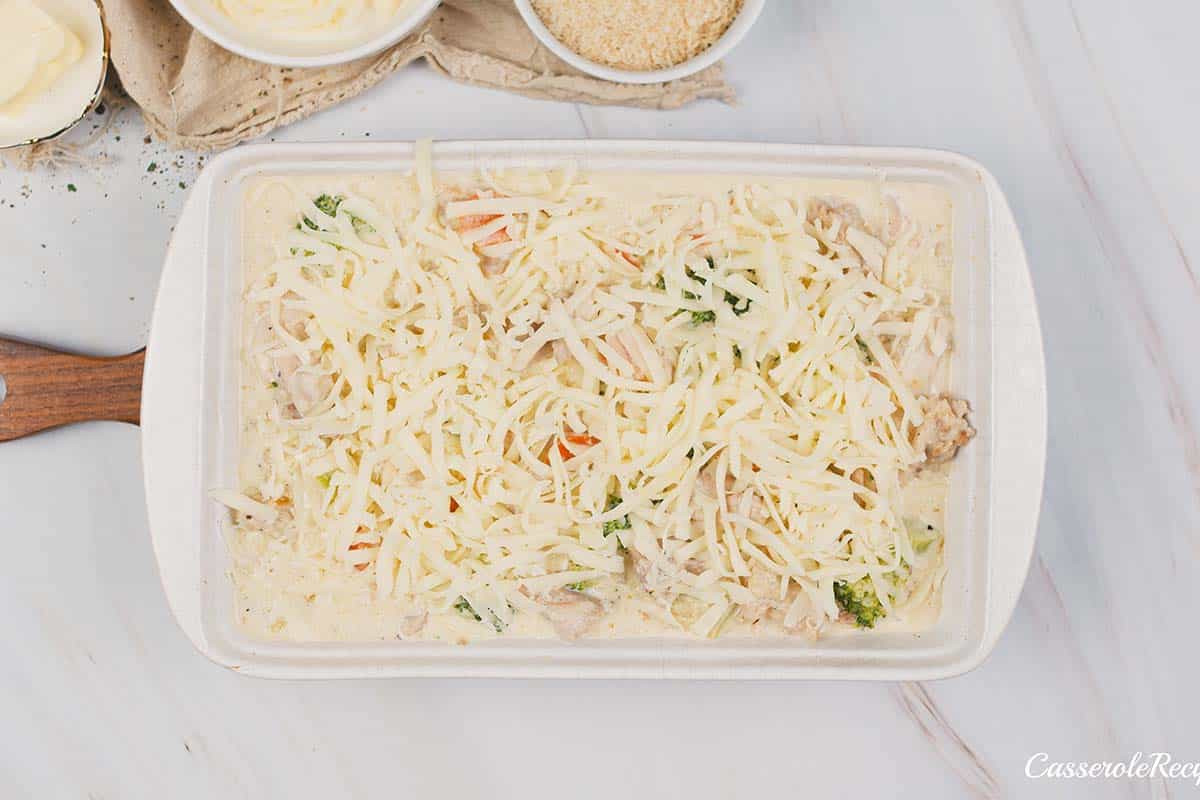 topping chicken divan with cheese prior to baking