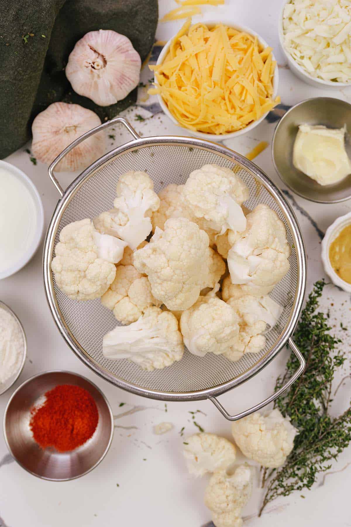 overhead view of ingredients to make creamy cauliflower casserole laid-out on a table