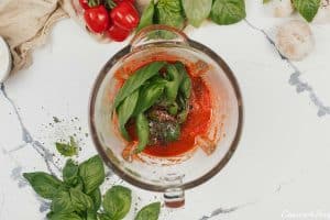 combining ingredients to make creamy sun-dried tomato and roasted red pepper casserole