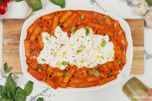 creamy sun-dried tomato and roasted red pepper casserole in a baking dish prepared to be served