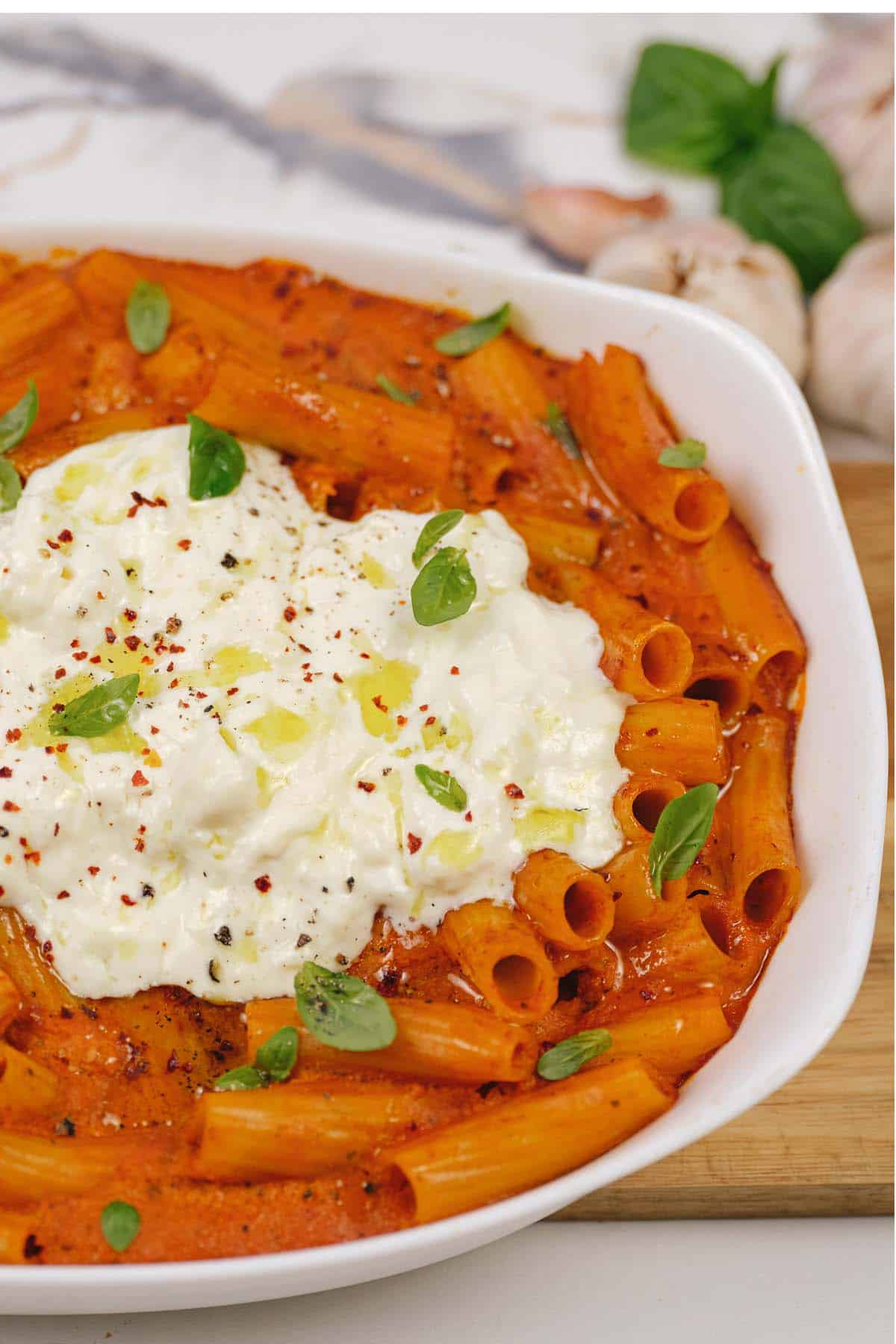 creamy sun-dried tomato and roasted red pepper casserole in a baking dish prepared to be served