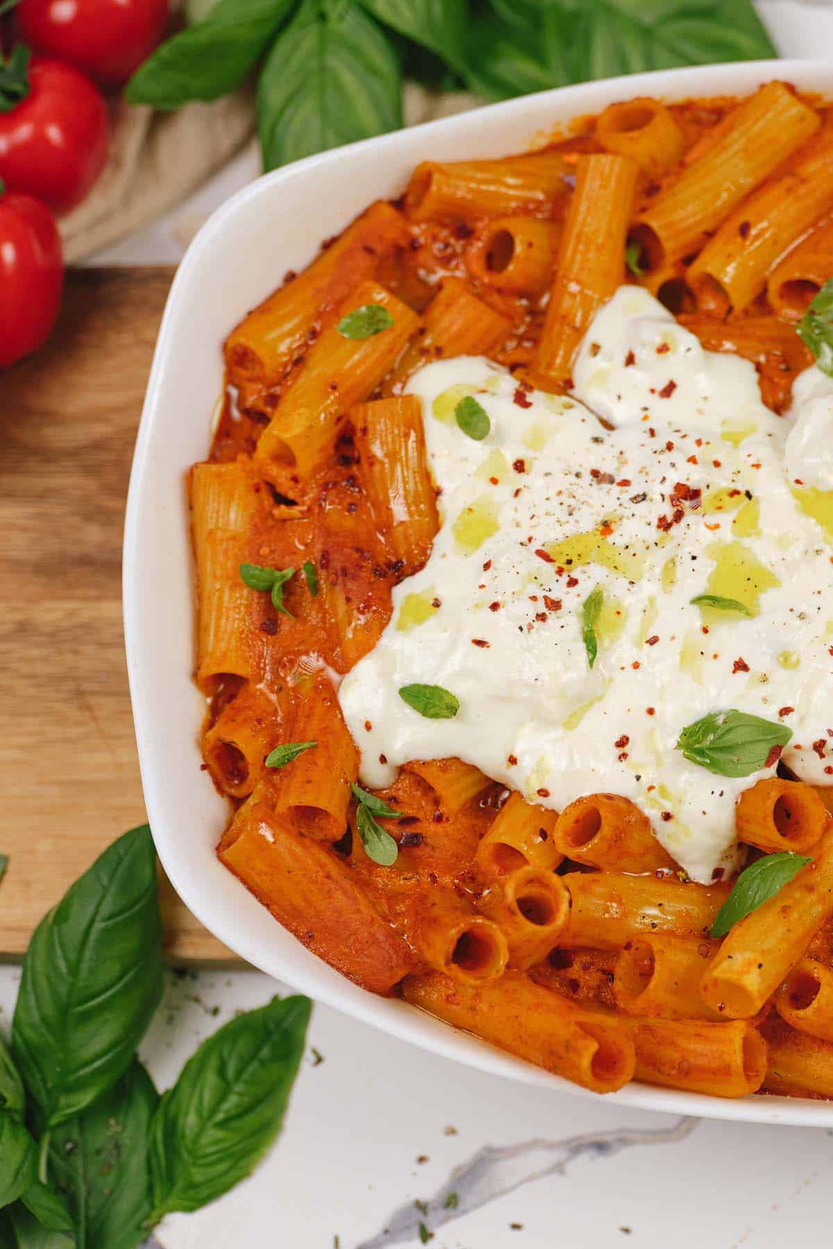 large baking dish filled with family-sized meal of creamy sun-dried tomato and roasted red pepper casserole