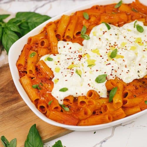 overhead view of baking dish filled with creamy sun-dried tomato and roasted red pepper casserole