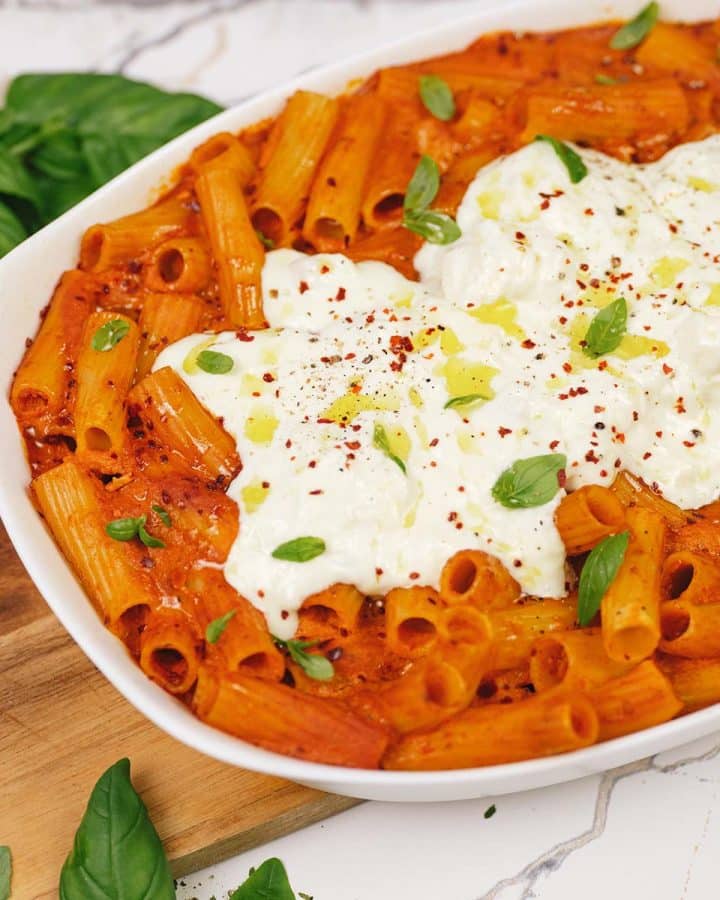 overhead view of baking dish filled with creamy sun-dried tomato and roasted red pepper casserole
