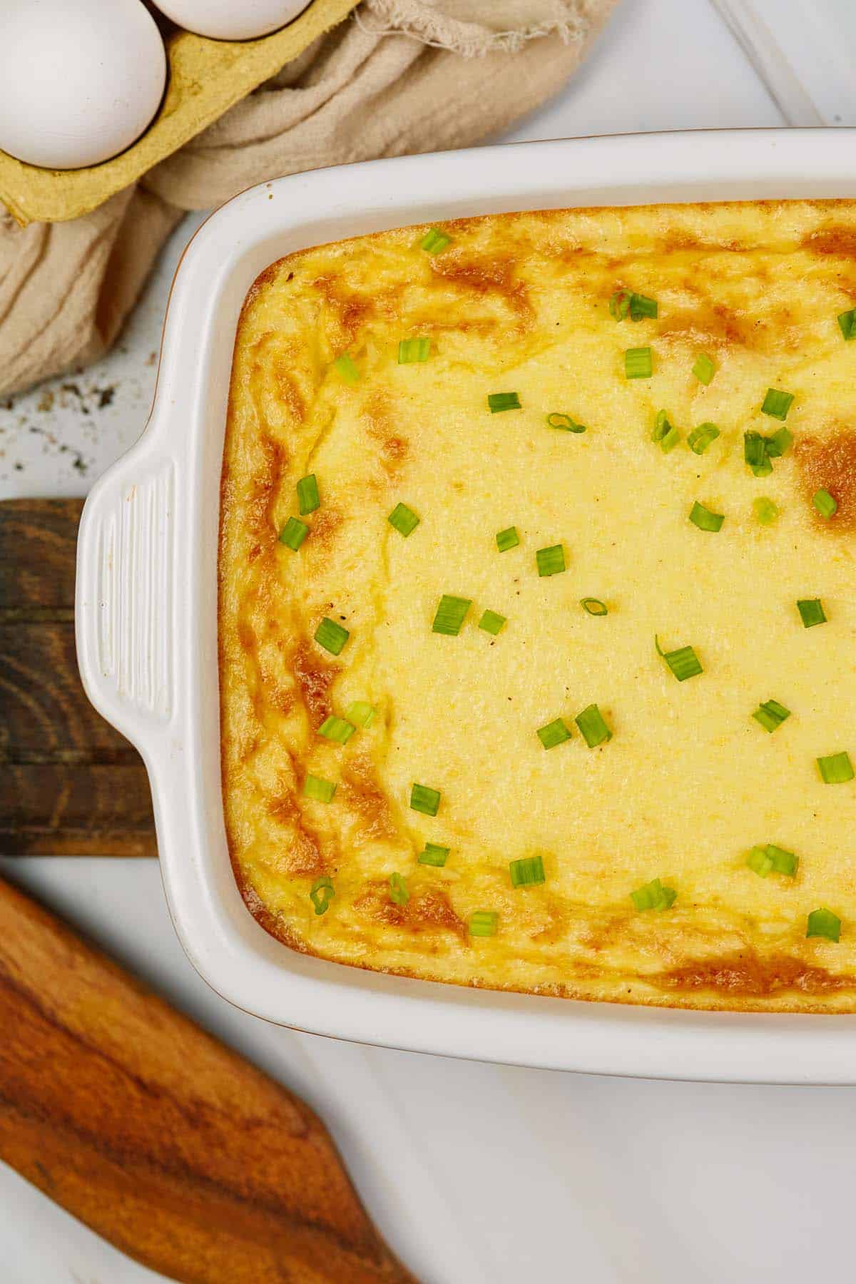 closeup of casserole dish of curried chicken and grits casserole on a table