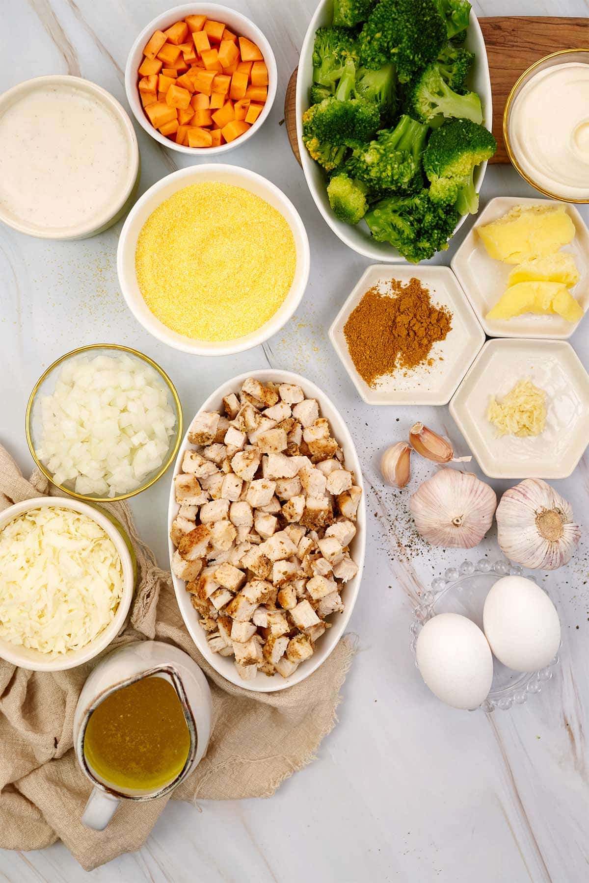 ingredients laid out on a table to make curried chicken and grits casserole