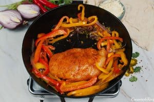 chicken and peppers being sautéed to make fajita chicken bake