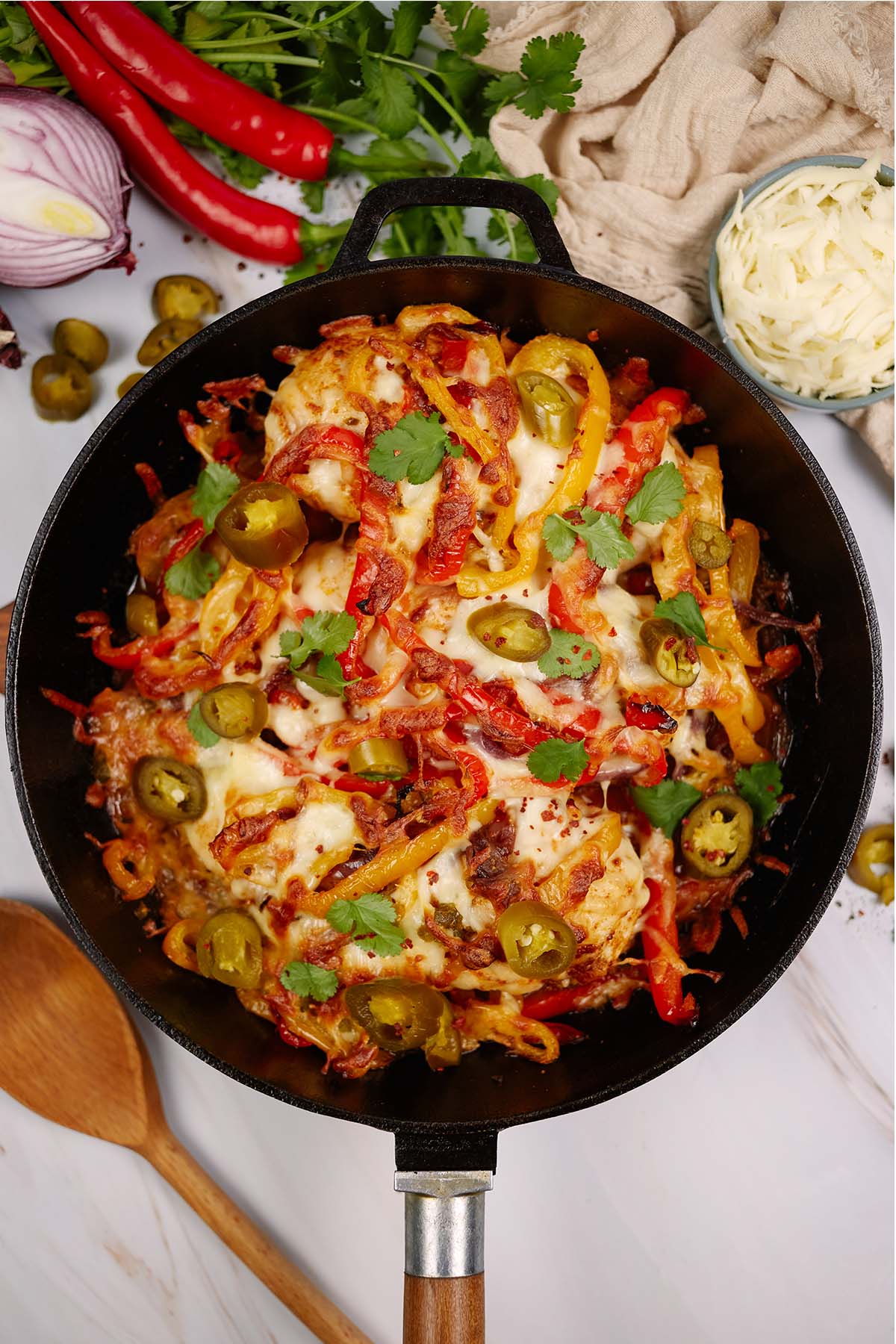 casserole dish of fajita chicken bake on a table surrounded by ingredients