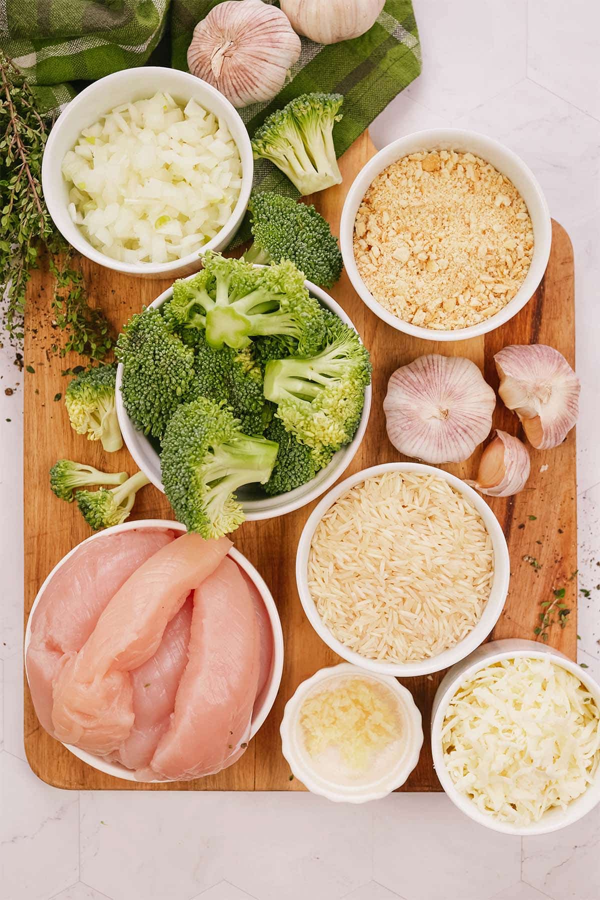 overhead view of ingredients to make garlic cheddar chicken bake on a table