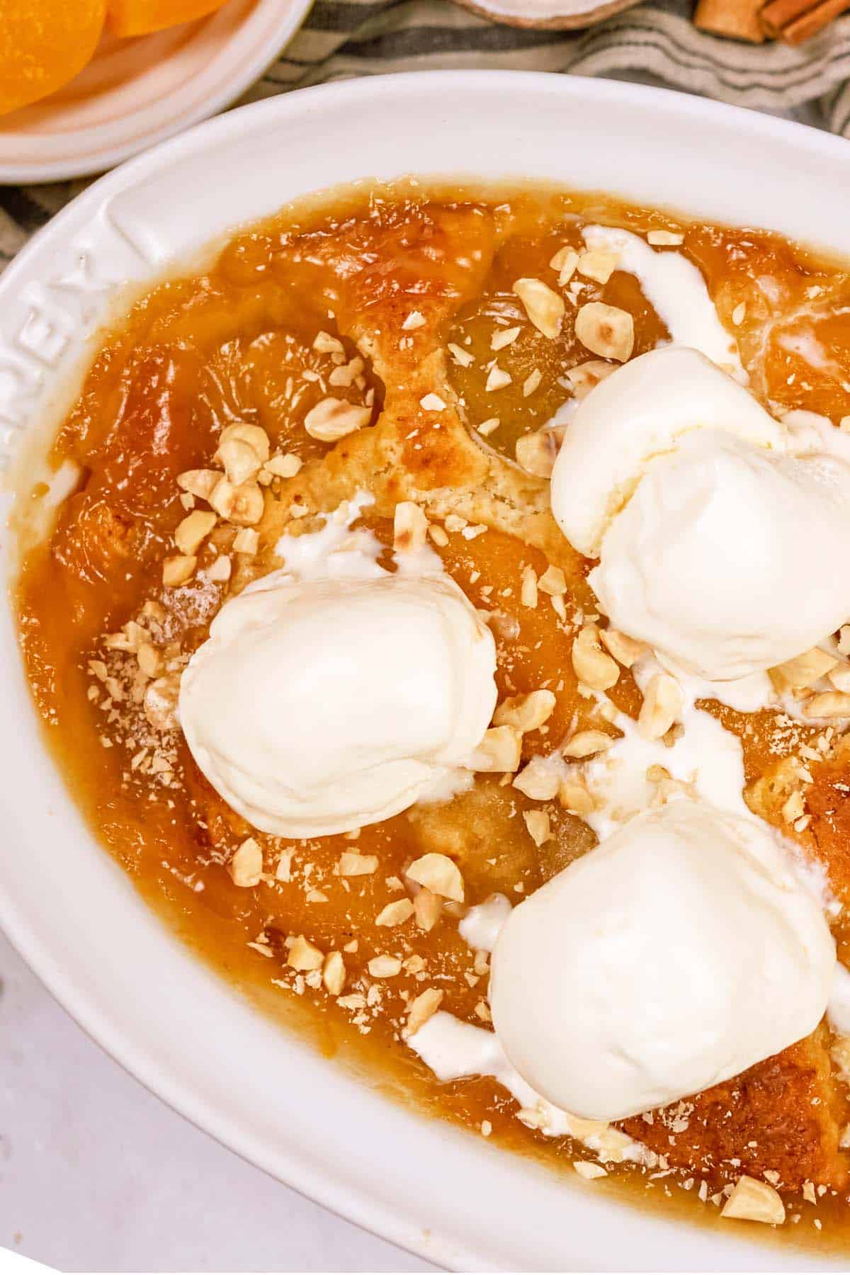 baking dish of peach, almond and caramel self-saucing pudding