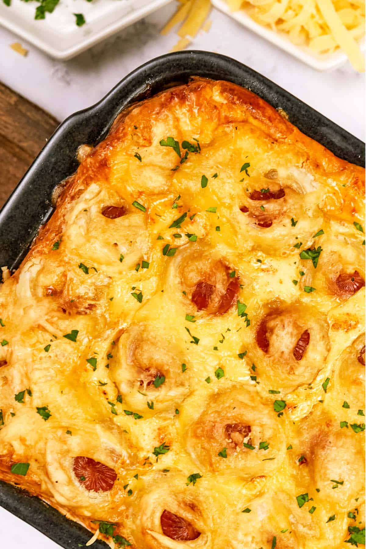 baking dish of pigs in a blanket breakfast casserole ready to serve