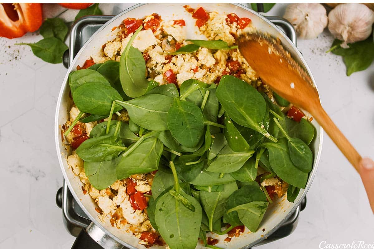 adding greens to scrambled tofu casserole