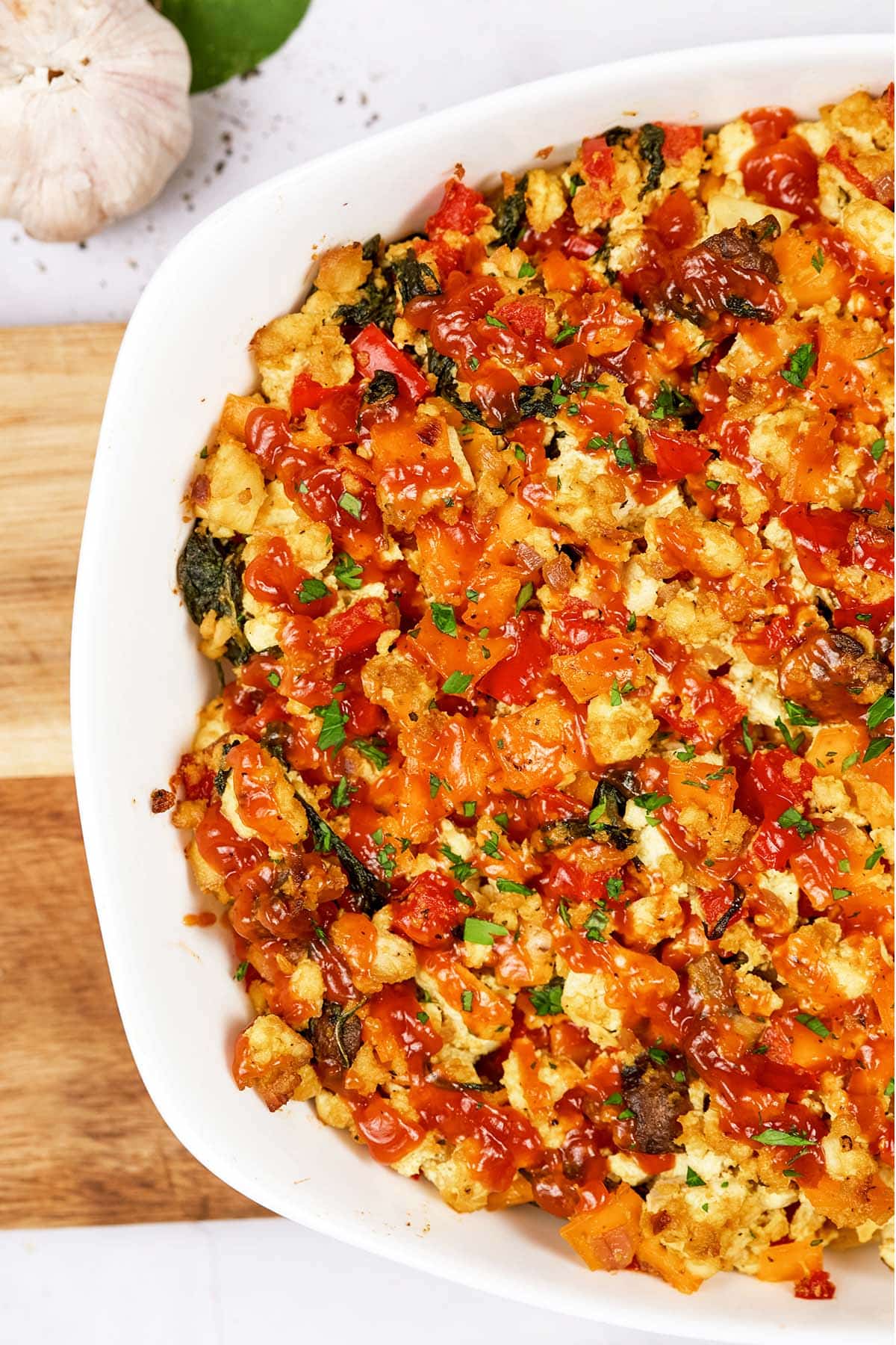closeup of scrambled tofu casserole in a baking dish prepared to serve