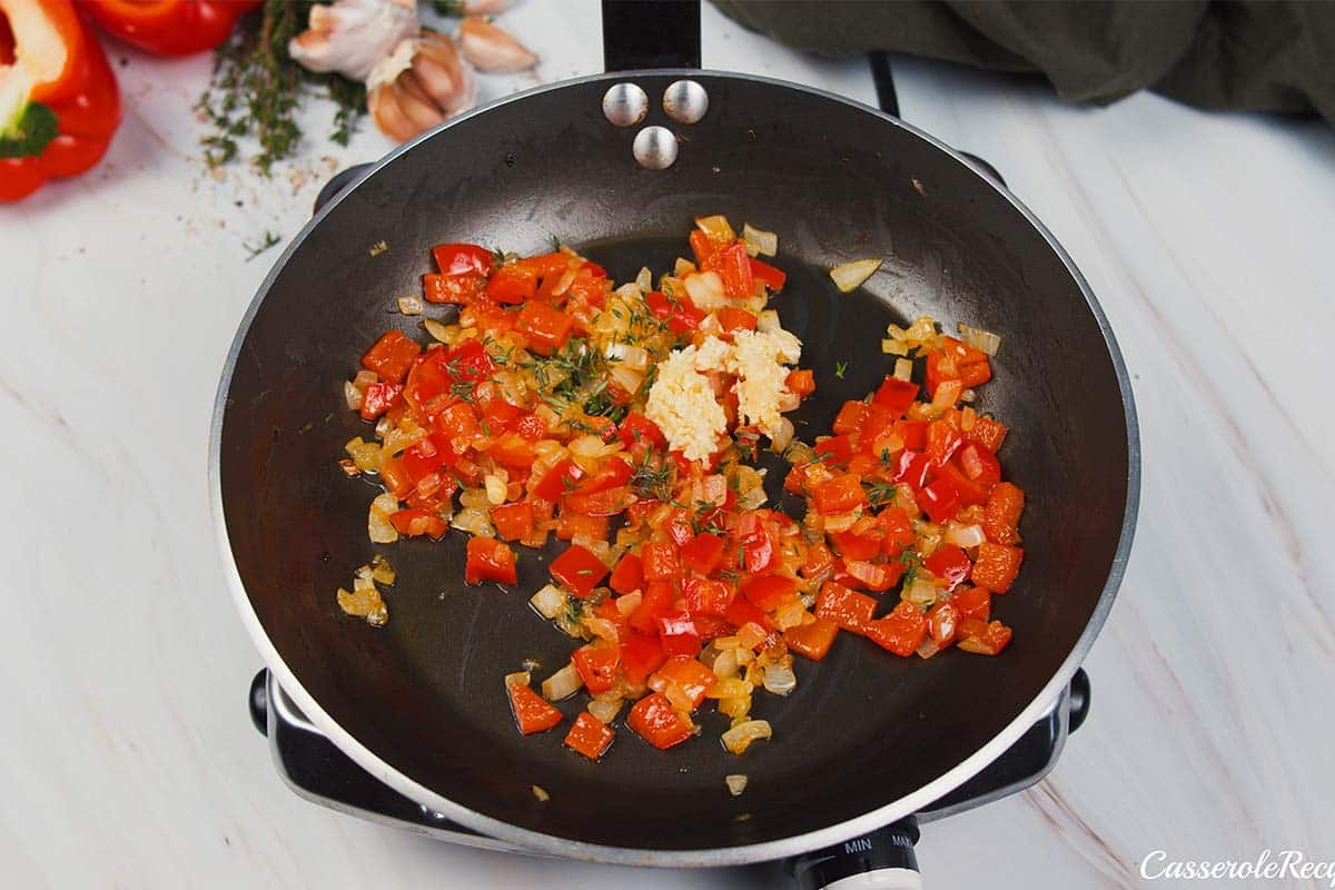 vegetables being sautéed to make shrimp and grits bake