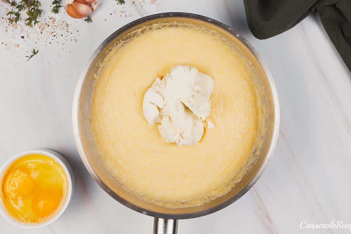 ingredients being added to a saucepan to make shrimp and grits bake