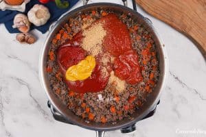 ingredients being added to a pot to make flaky sloppy joe casserole