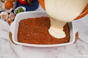 final step prior to baking a flaky sloppy joe casserole by pouring the batter mixture on top