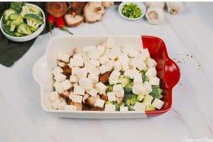 layering the ingredients in a baking dish to make teriyaki tofu rice casserole