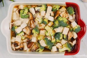 final step of combining ingredients in a baking dish to make teriyaki tofu rice casserole