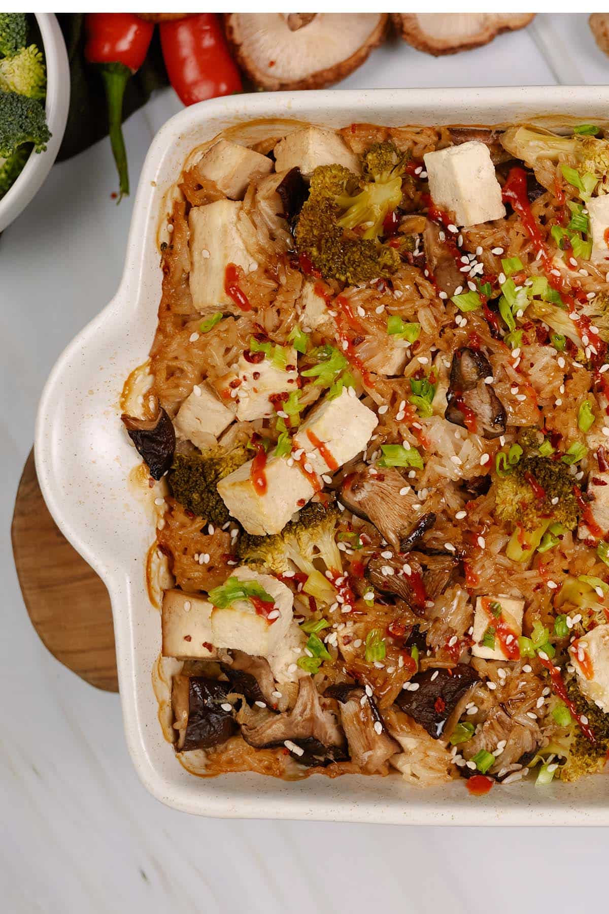 baking dish of teriyaki tofu rice casserole on a table with ingredients