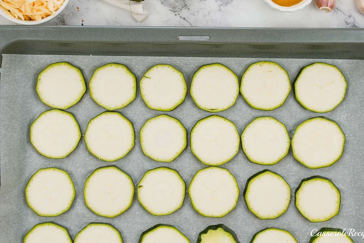 sliced zucchini laid out to make zucchini tomato casserole