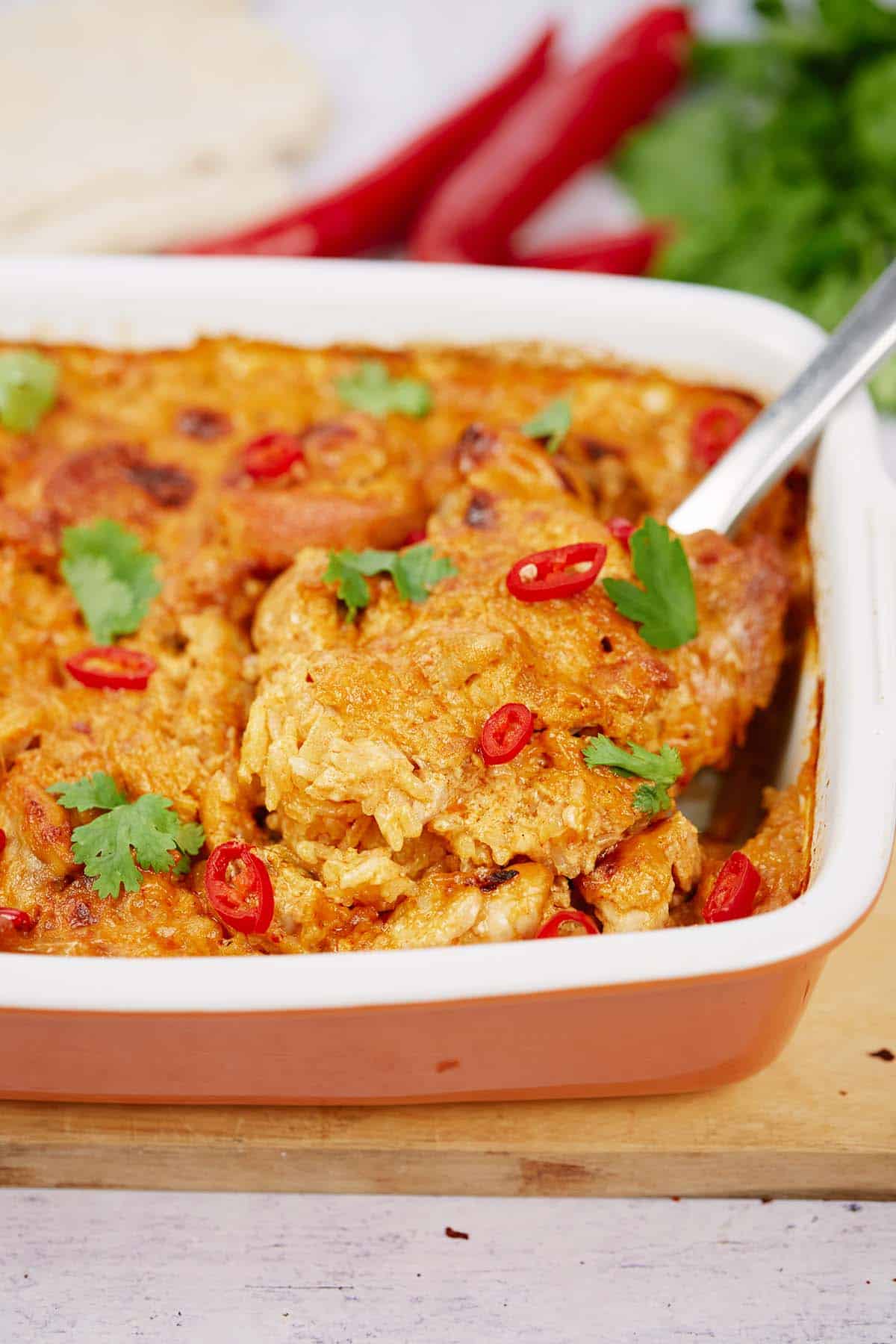 spatula lifting a serving of Chicken Panang Casserole from a baking dish