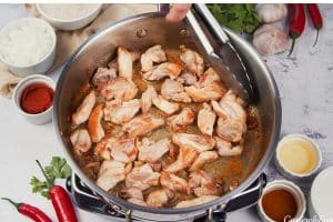 chicken being cooked to make Chicken Panang Casserole