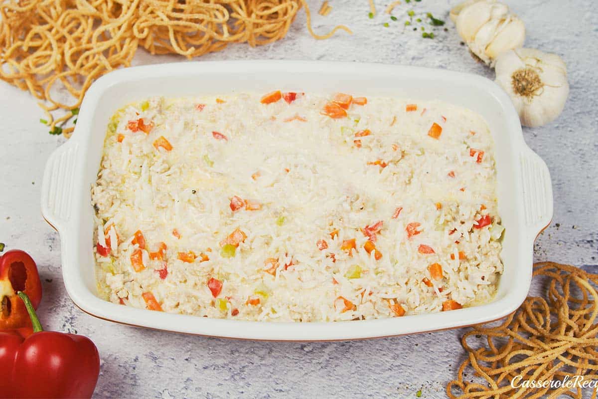 layering ingredients into a baking dish to make Chicken chow mein casserole