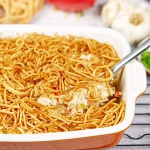 Serving of Chicken chow mein casserole being lifted from a baking dish