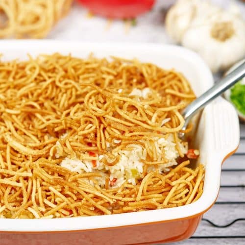 Serving of Chicken chow mein casserole being lifted from a baking dish