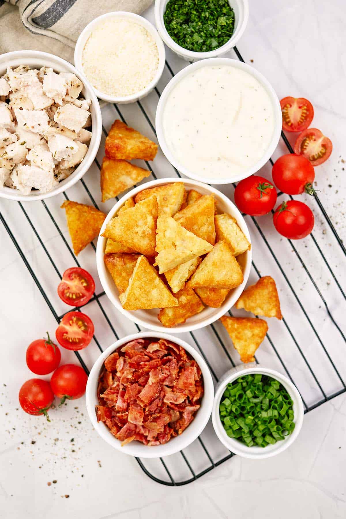 ingredients to make alfredo bacon tot casserole laid out on a table