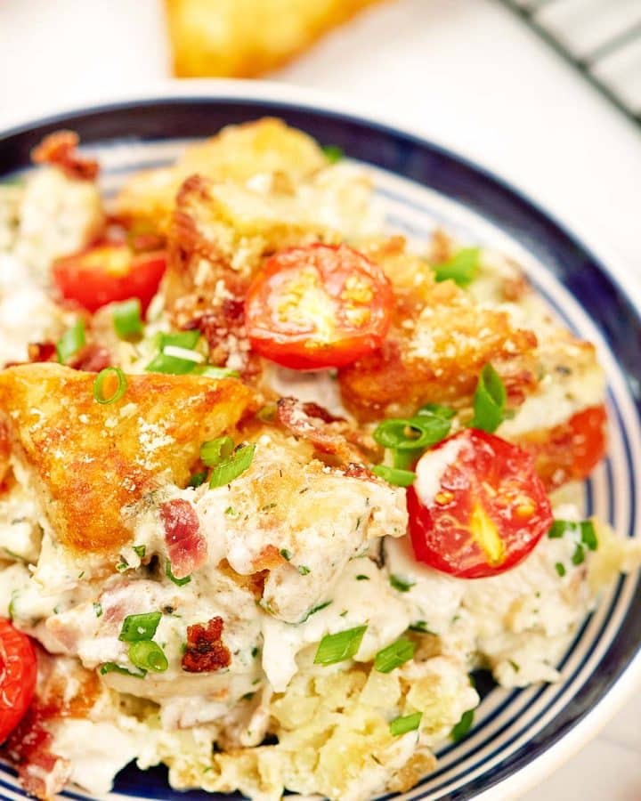 alfredo bacon tot casserole served in a bowl ready to enjoy