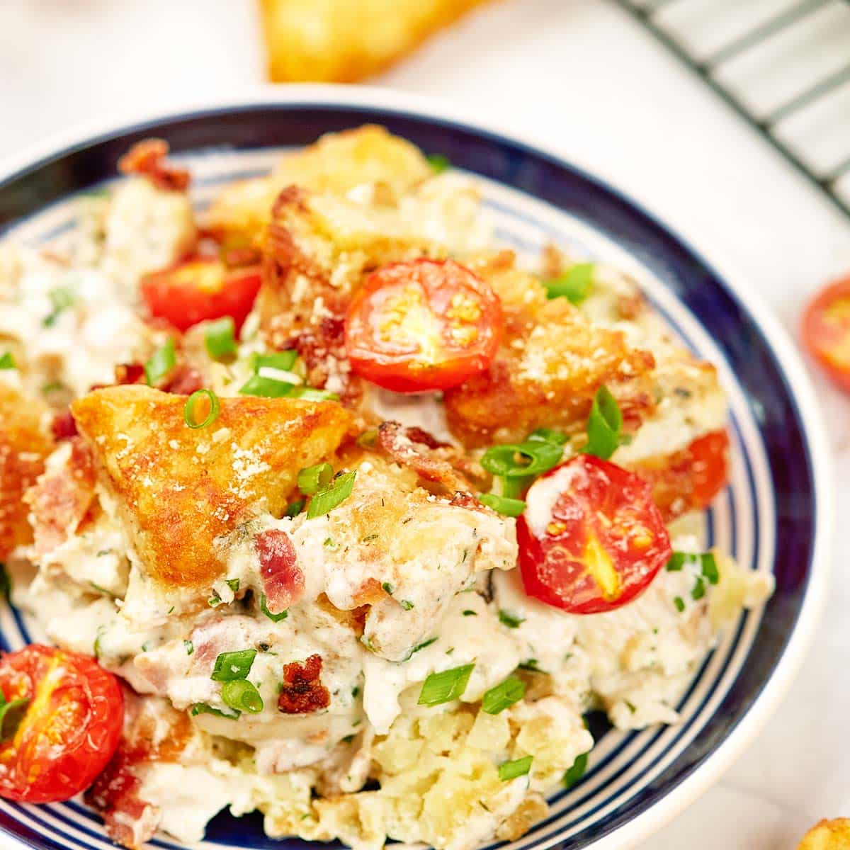 alfredo bacon tot casserole served in a bowl ready to enjoy