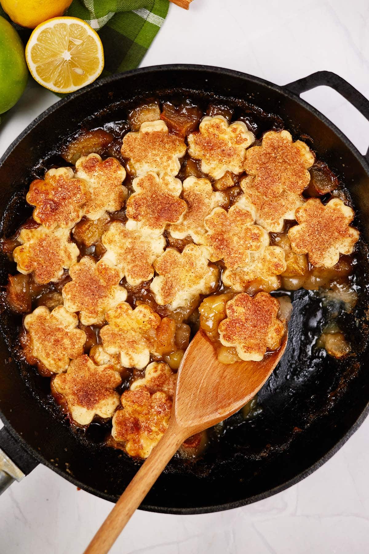 spoon scooping up a serving of apple pandowdy from a skillet